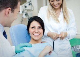 Dental patient with dentist and dental nurse