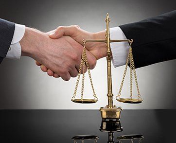Businessman Shaking Hands In Front Of Scale — Attorney in Morris Plains, NJ Businessman Shaking Hands In Front Of Scale — Attorney in Morris Plains, NJ
