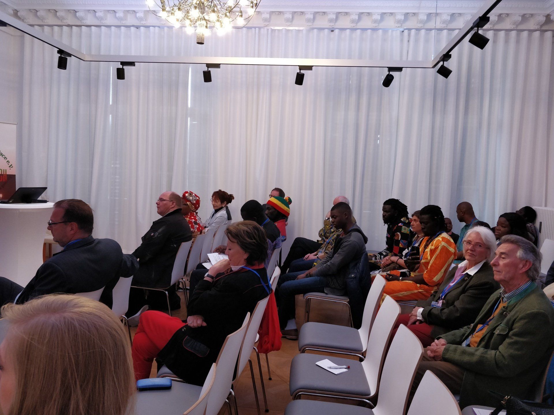A group of people are sitting in chairs in a room