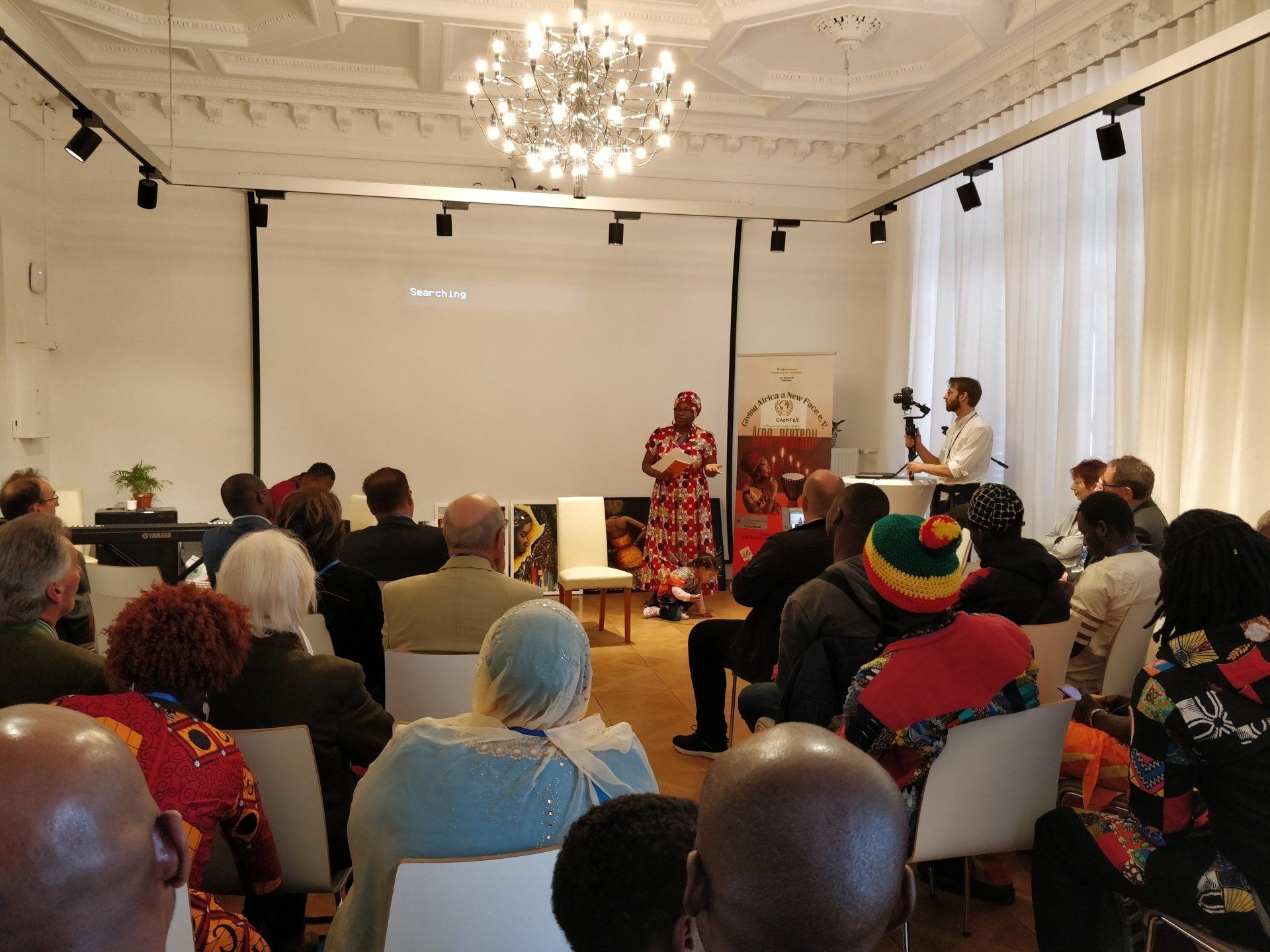 A woman is giving a presentation to a group of people in a room.