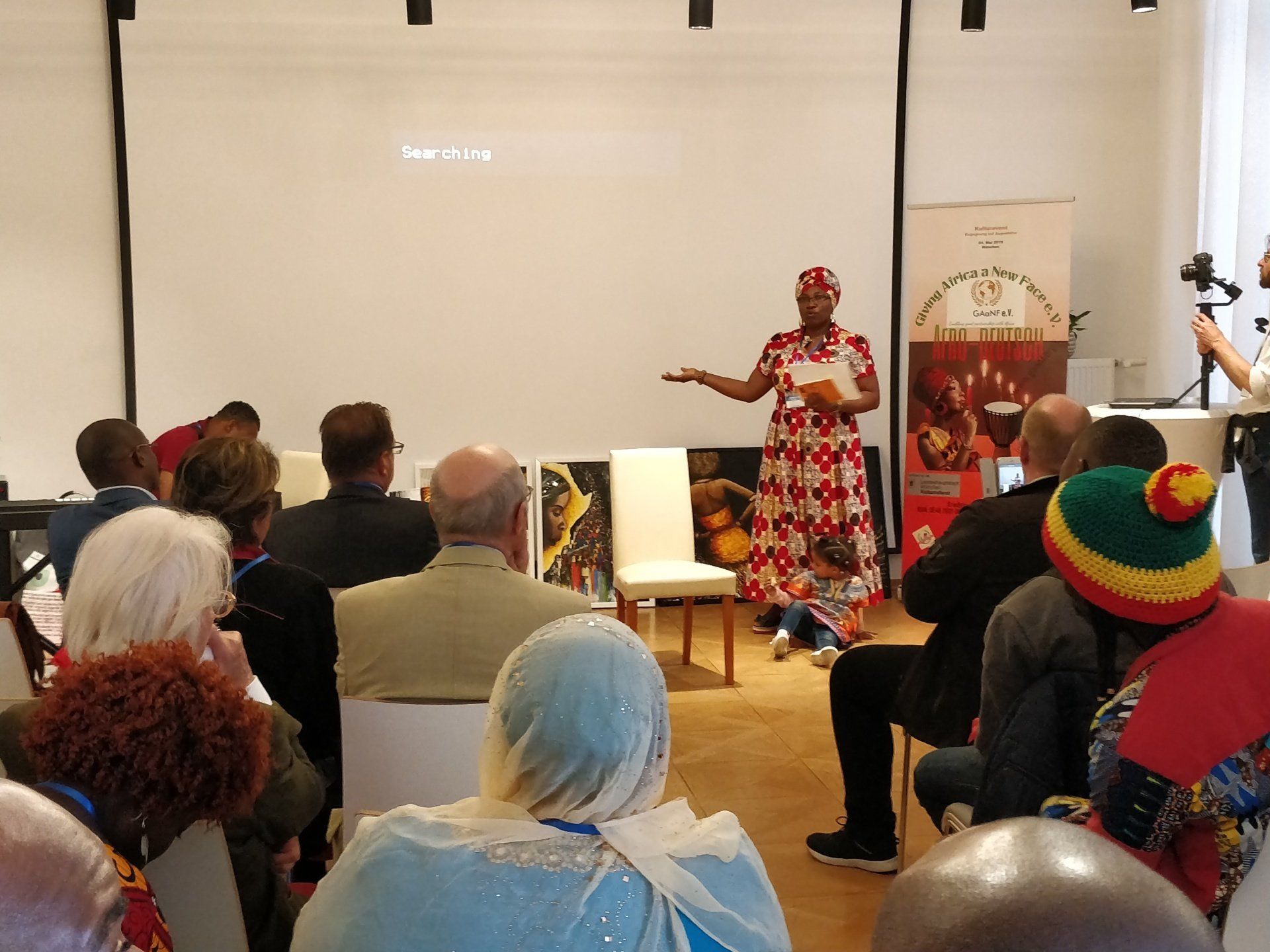 A woman is giving a presentation to a group of people