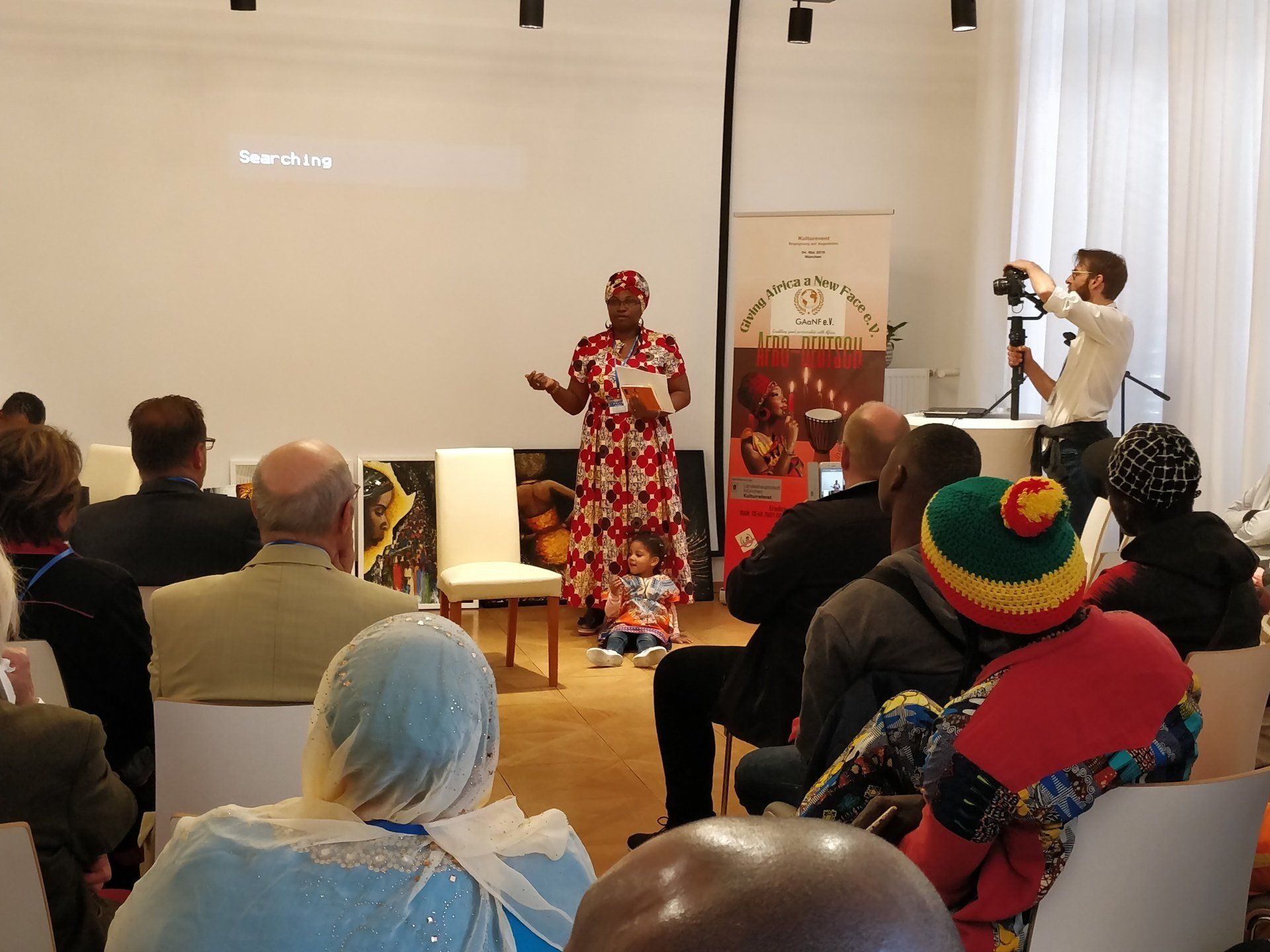 A woman is giving a presentation to a group of people