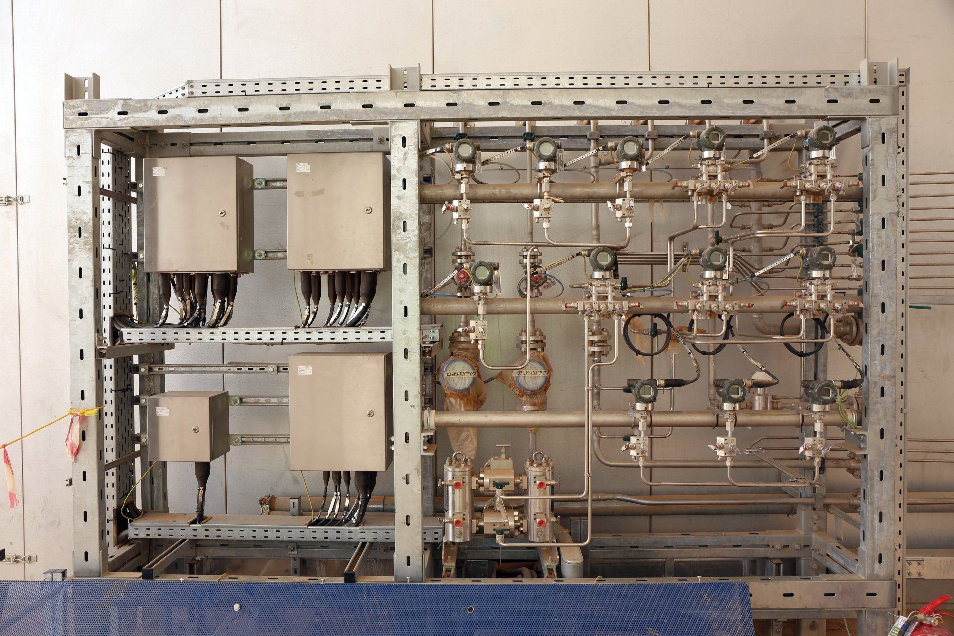 Metal frame with control panels and complex piping for gas flow.