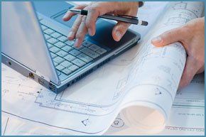 Architectural plans from Khawaja Planning Services A laptop and blue prints accessed by a planning professional