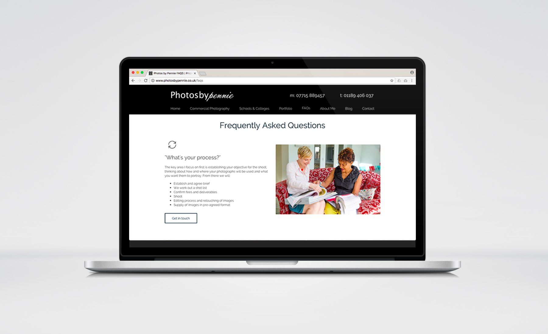 A laptop computer is open to a website with two women sitting on a couch.