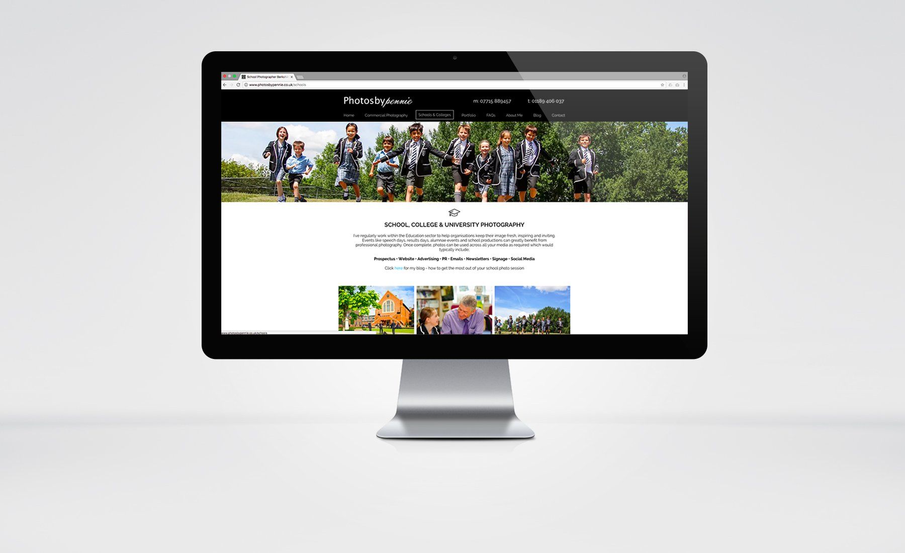 A computer monitor is displaying a website with a group of people on it.