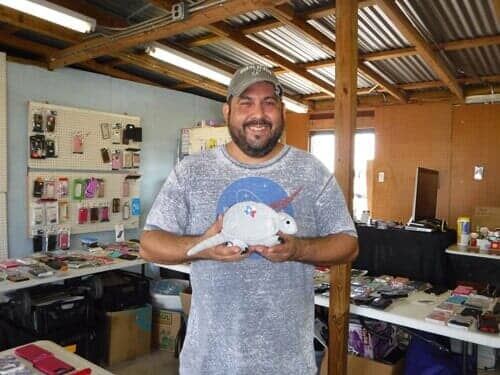 Man holding a coin bank — Flea Market in Schertz, TX