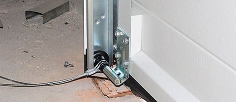 Garage Door Maintenance — Close Up on Installing Garage Door in Johnson City, TN Garage Door Maintenance — Close Up on Installing Garage Door in Johnson City, TN