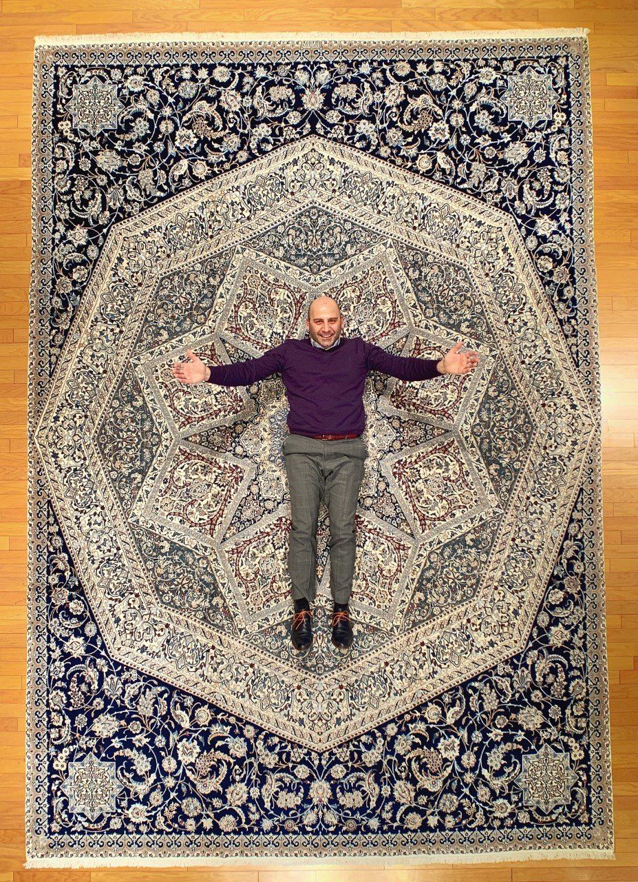 Man Lying on a Big Carpet — Milwaukee, WI — Shabahang and Sons Persian Carpets