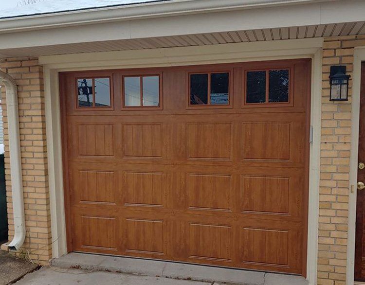 Wooden Garage Door With Four Windows — Port Washington, WI — Jiffy Overhead Door, LLC Wooden Garage Door With Four Windows — Port Washington, WI — Jiffy Overhead Door, LLC