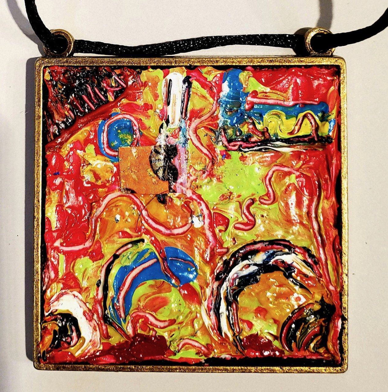 A necklace with a colorful painting on it