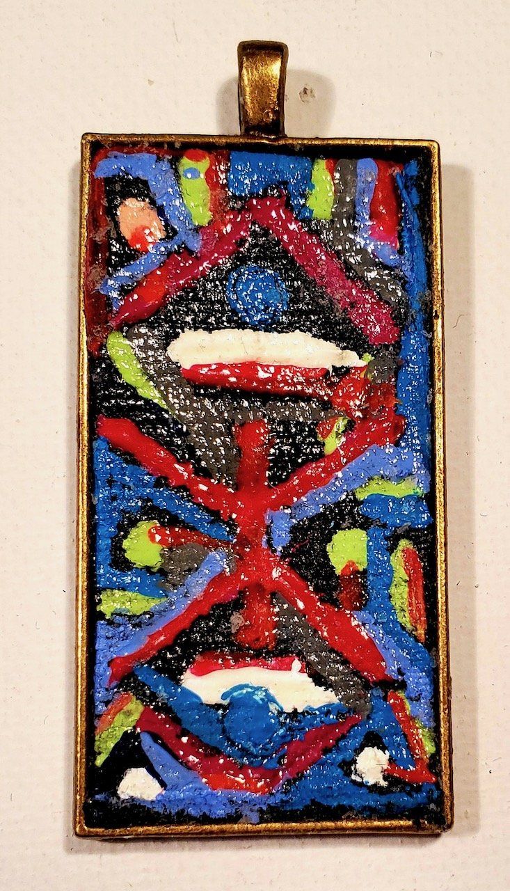 A pendant with a colorful design on it