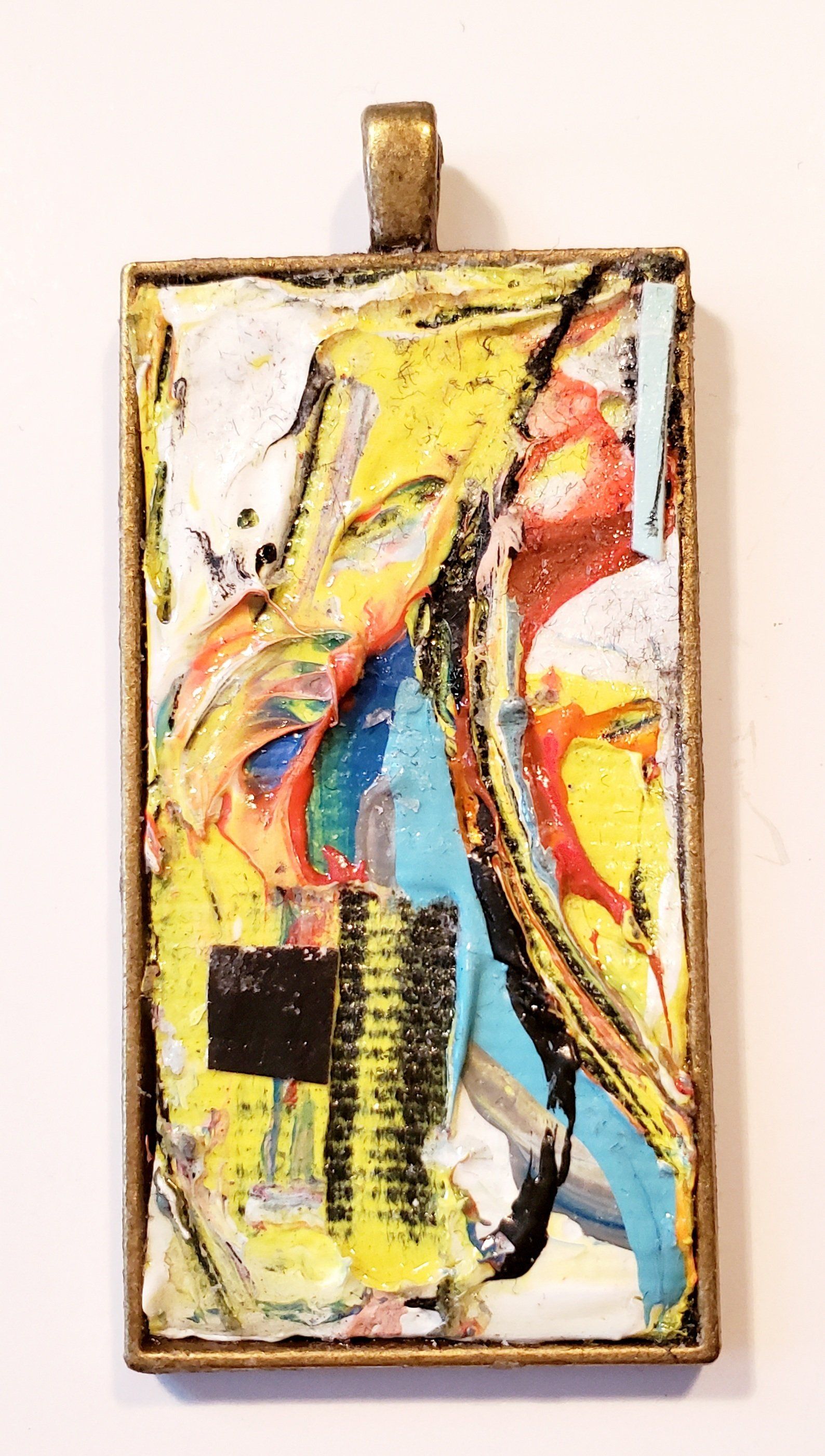 A pendant with a colorful painting on it