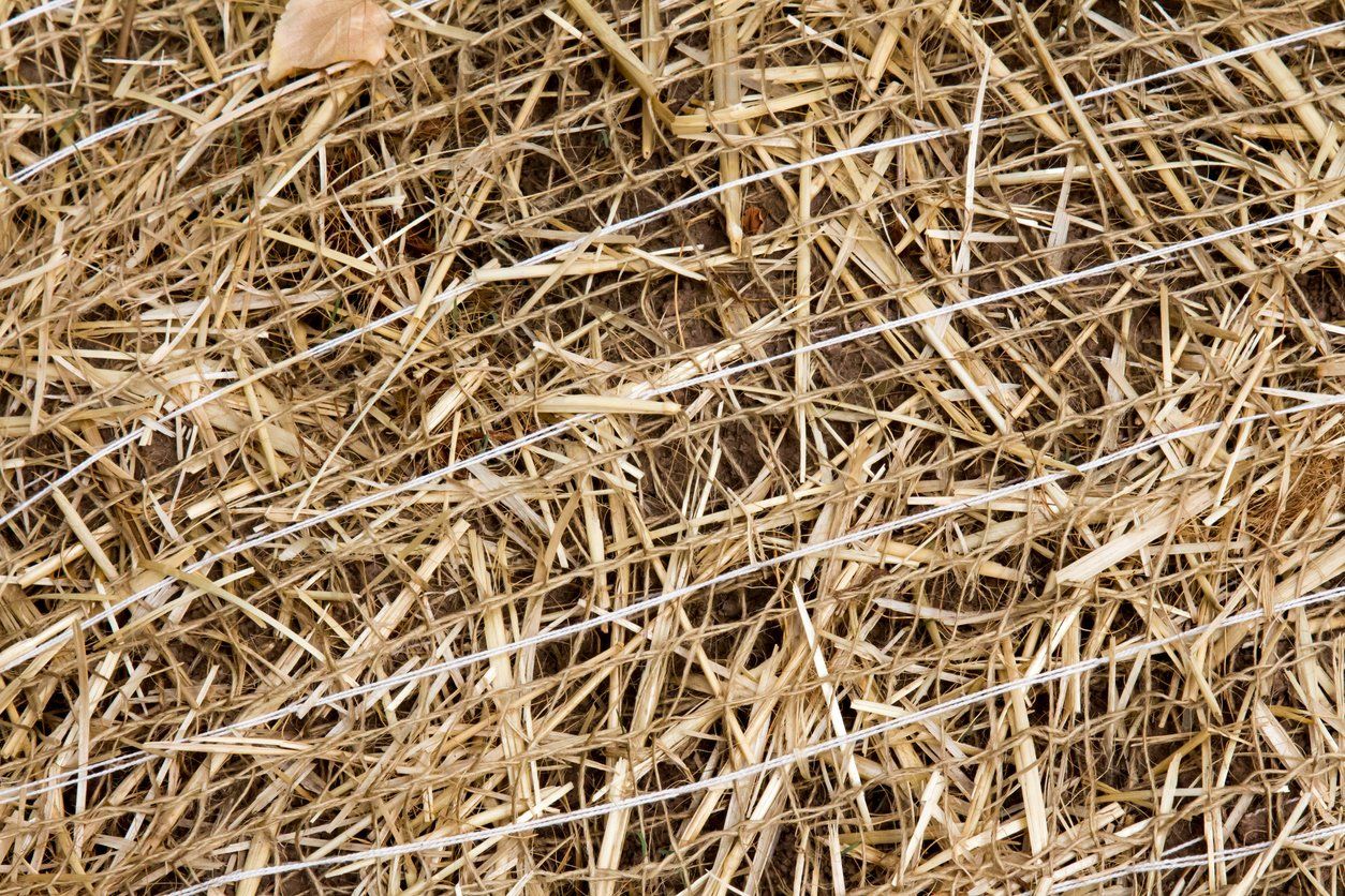 Close-up of dry straw or hay tangled in a tan and brown pile