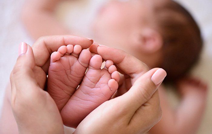 Infant Massage — Holding Baby's Foot in Albuquerque, NM