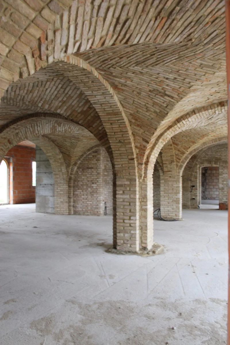 ampia sala con archi e colonne in mattoncini