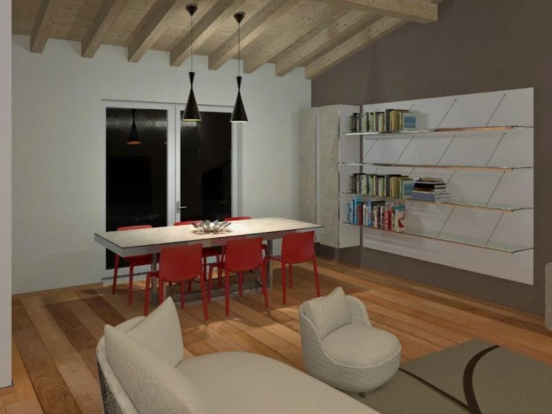 sala open space con tavolo da pranzo e sedie rosse