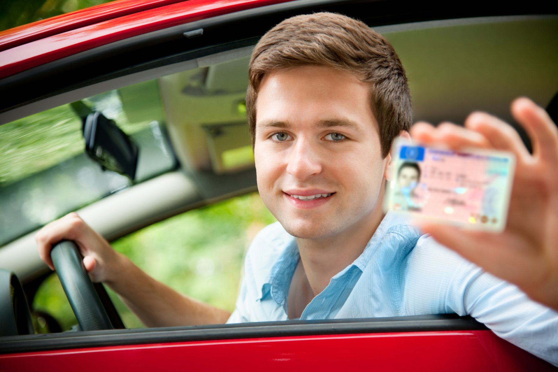 Close Up Photo Of A Man With His Driver License — North Hills, CA — Atlas Driving & Traffic School