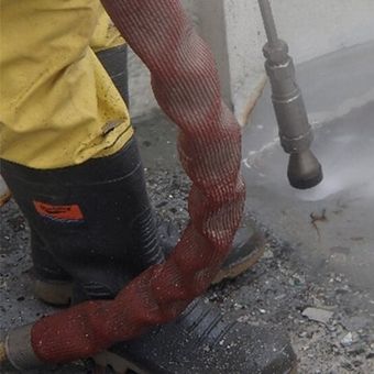 person waterblasting a boat