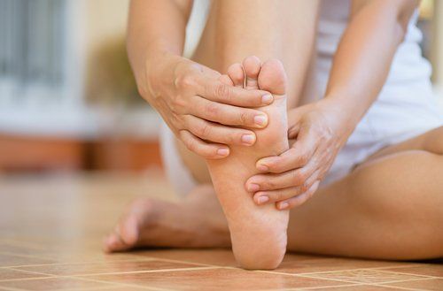 Woman Feeling Pain in Her Foot — Fresno, CA — Dr. Brent L Woodbury DPM