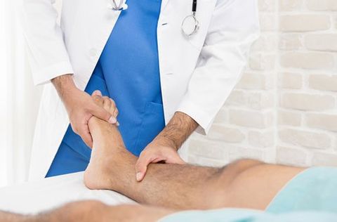 Doctor Giving Treatment to Broken Foot — Fresno, CA — Dr. Brent L Woodbury DPM Doctor Giving Treatment to Broken Foot — Fresno, CA — Dr. Brent L Woodbury DPM