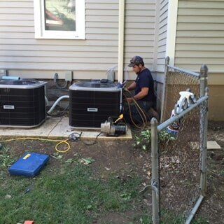 Man Repairing Condenser — Residential HVAC Contractors in Mount Vernon, OH Man Repairing Condenser — Residential HVAC Contractors in Mount Vernon, OH