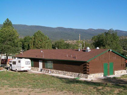 A house with a rv parked in front of it