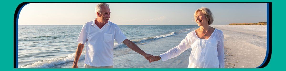 Happy couple walking on the beach