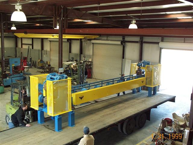 A large yellow and blue machine is being built in a factory