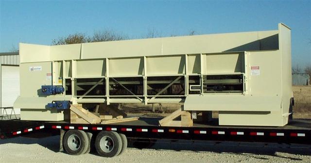 A large machine is sitting on top of a trailer.