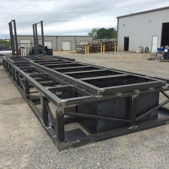 A large metal structure is sitting in front of a building