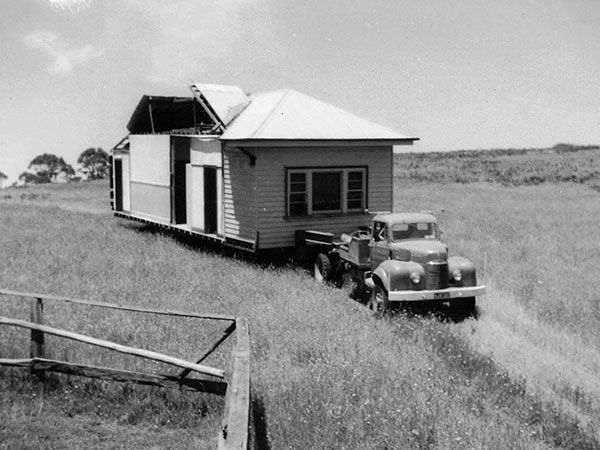 vintage truck pulling home on trailer