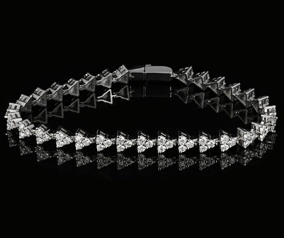 Black crystal-studded bracelet with repeating triangular links on a black background