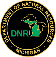 Michigan Department of Natural Resources logo with green state outline on black and gold seal