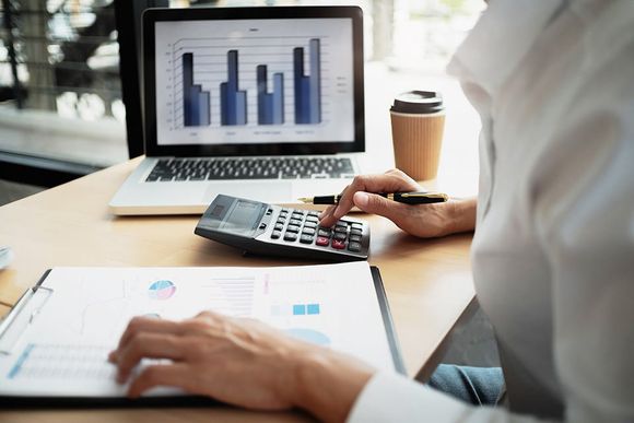 man doing calculations using his calculator