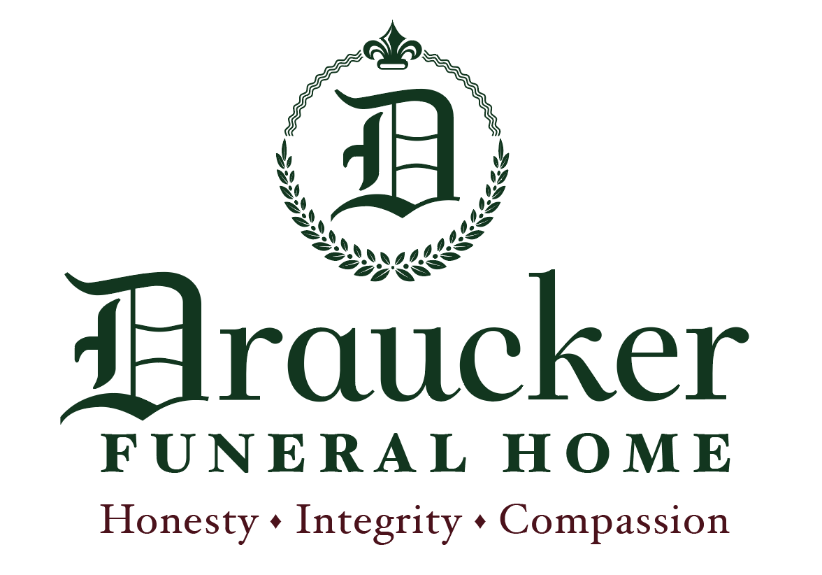 A logo for araucker funeral home with a laurel wreath