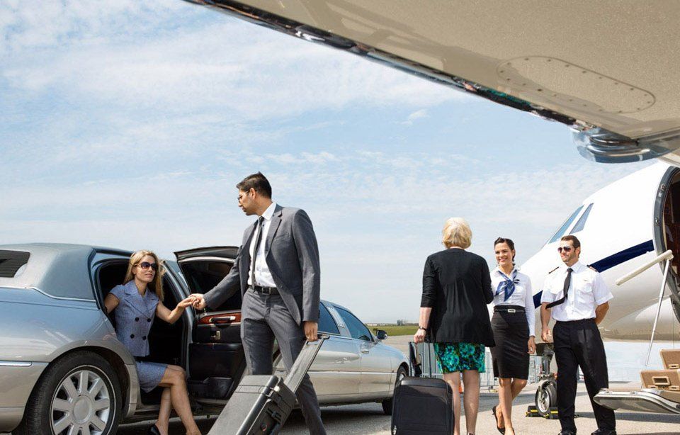 People exiting a limousine near a private jet, with flight crew assisting. Sunny outdoor setting.