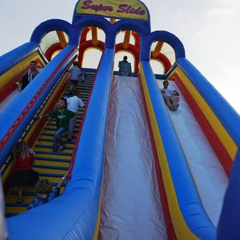 Kids on giant slide bouncer