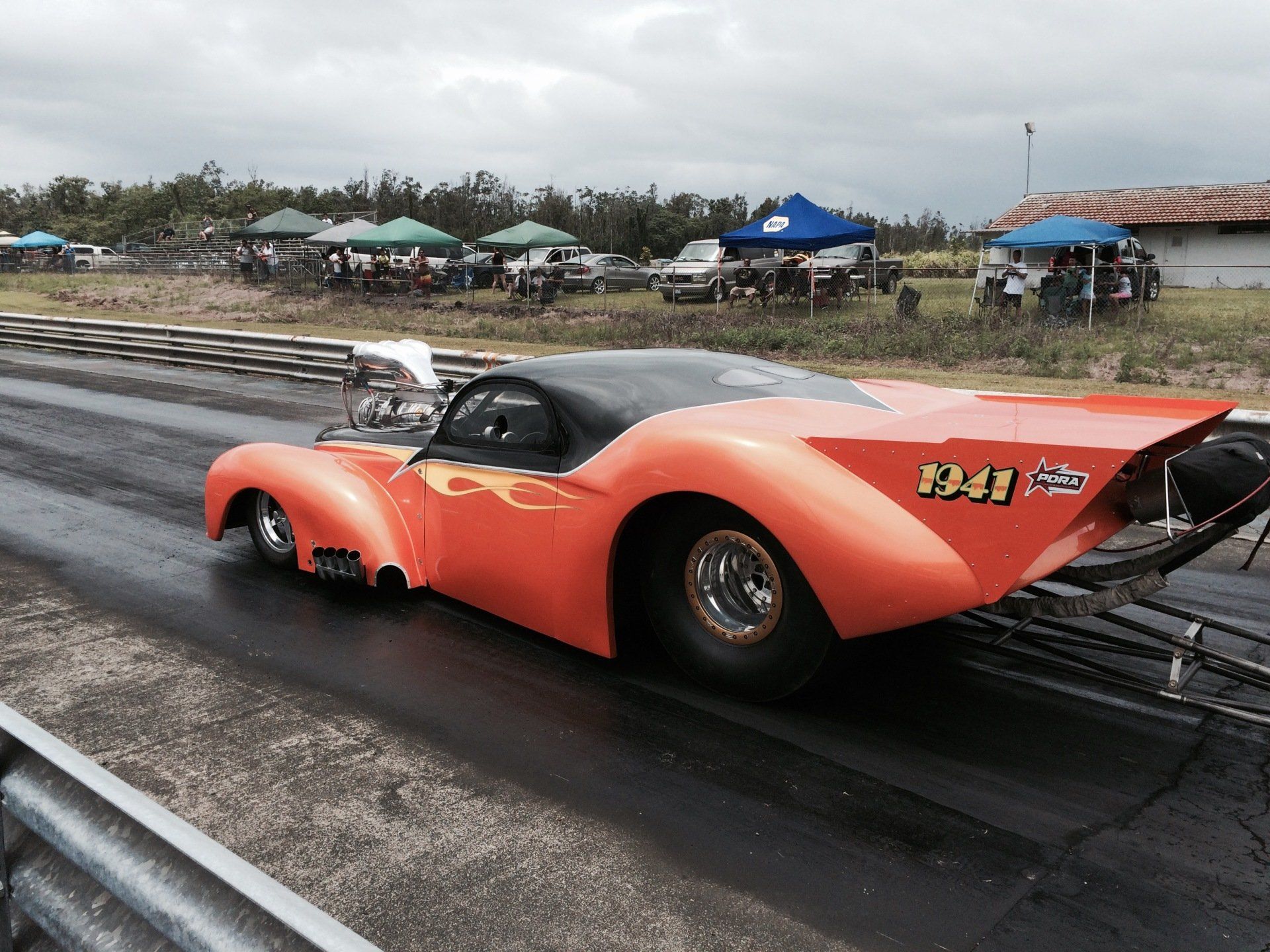 An orange race car with the number 1341 on the side