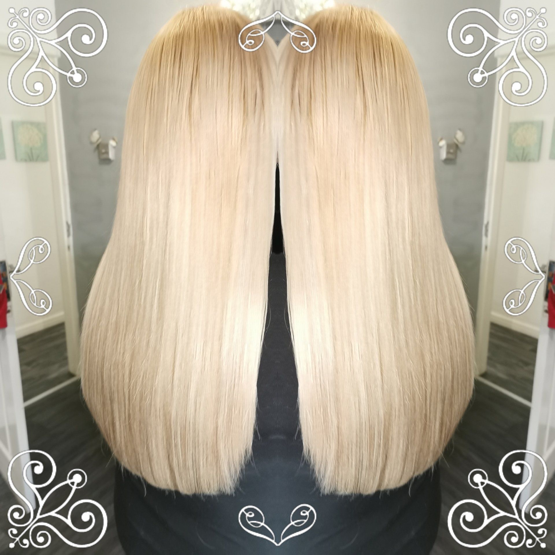 A woman 's blonde hair is reflected in a mirror.