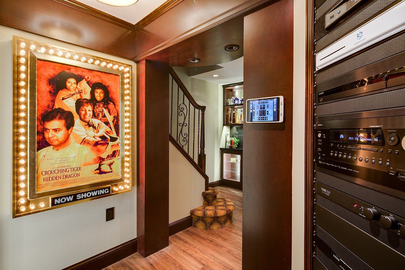 There is a picture of a movie on the wall in the hallway.