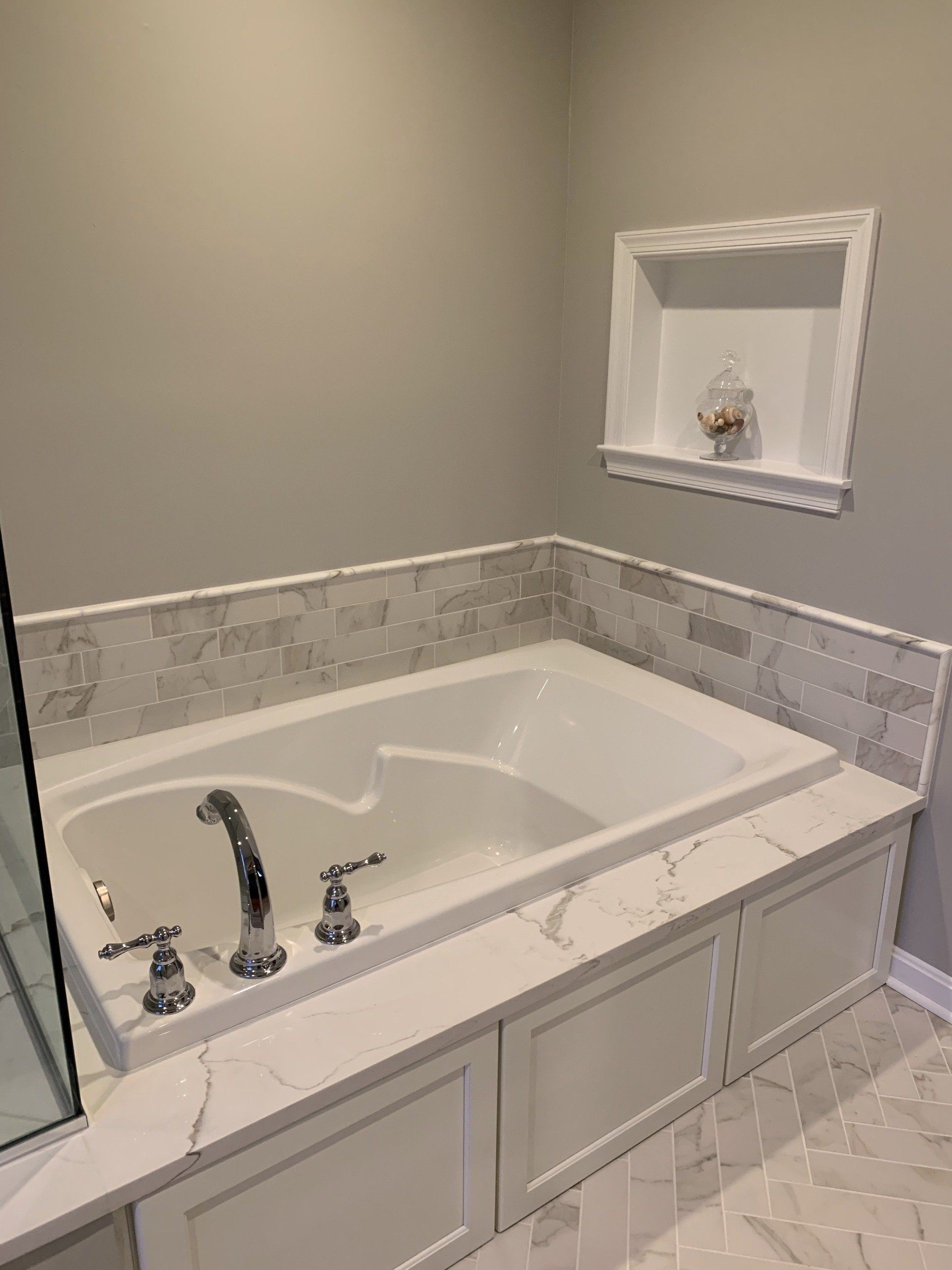 A bathroom with a bathtub and a shower.
