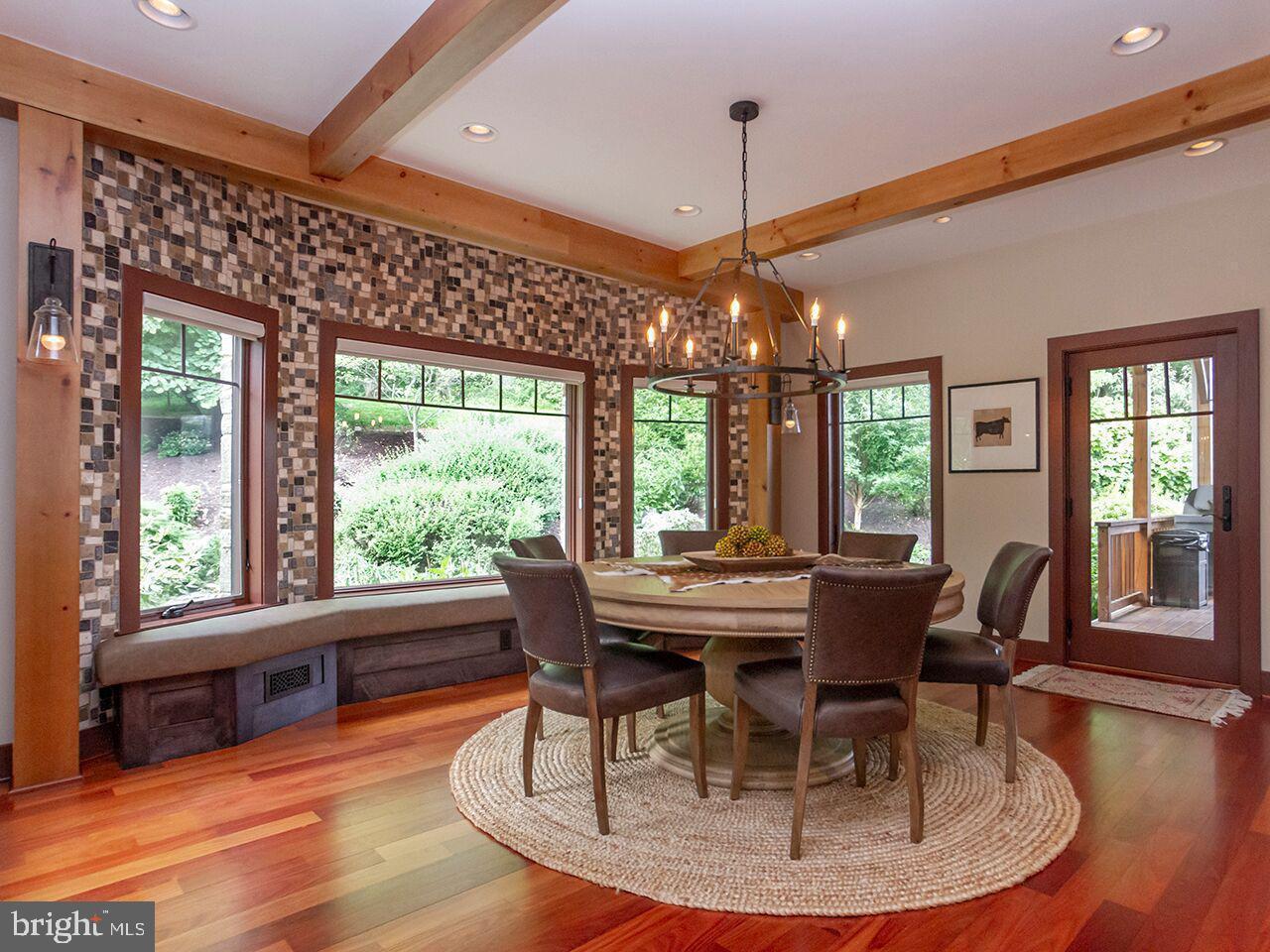 A dining room with a table and chairs and a chandelier.