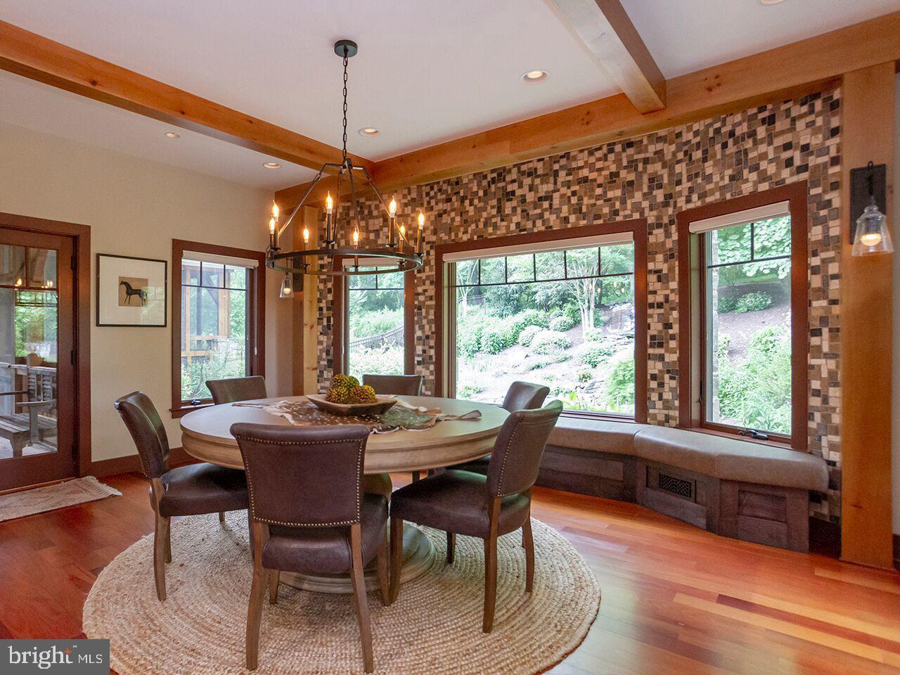 A dining room with a table and chairs and a chandelier.