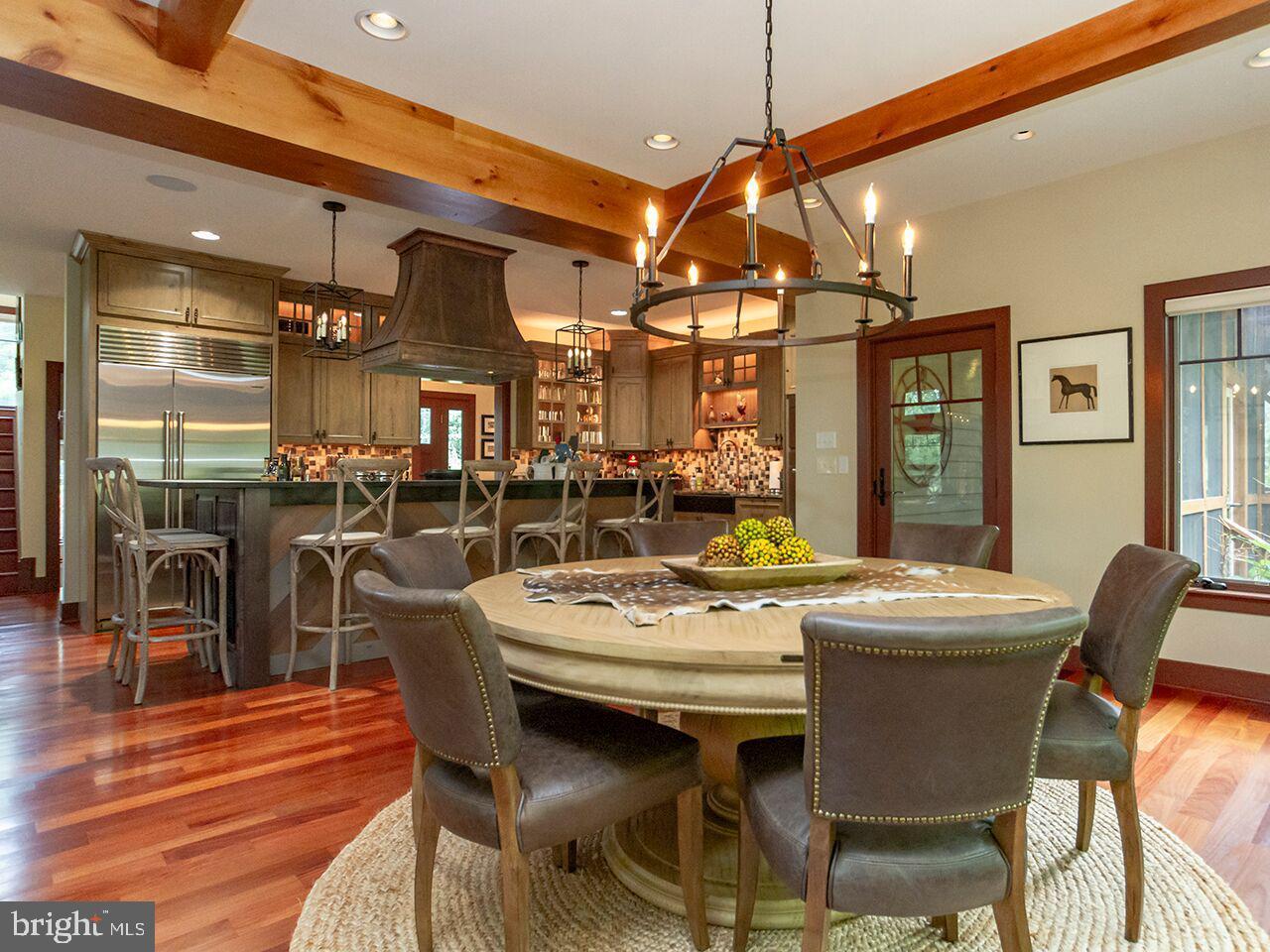 A dining room with a table and chairs and a chandelier