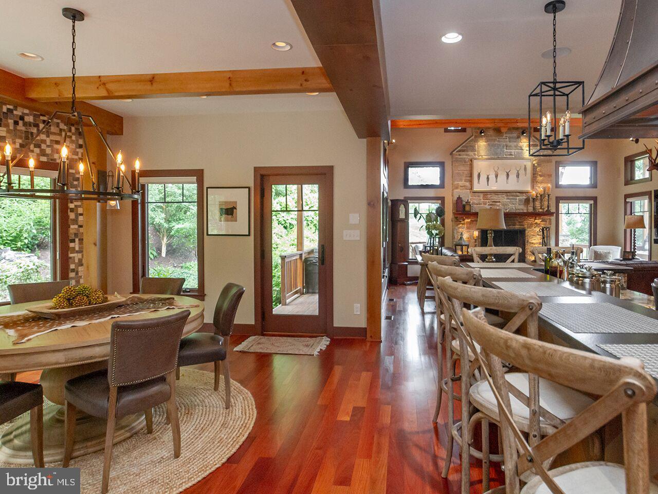 There is a table and chairs in the middle of the room.