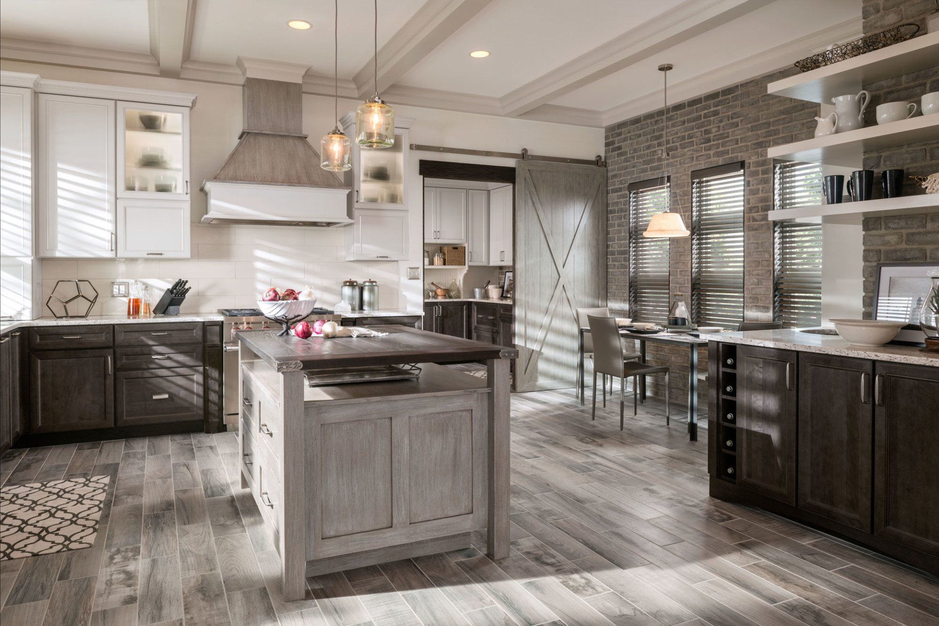 A kitchen with a large island in the middle and a sliding barn door.