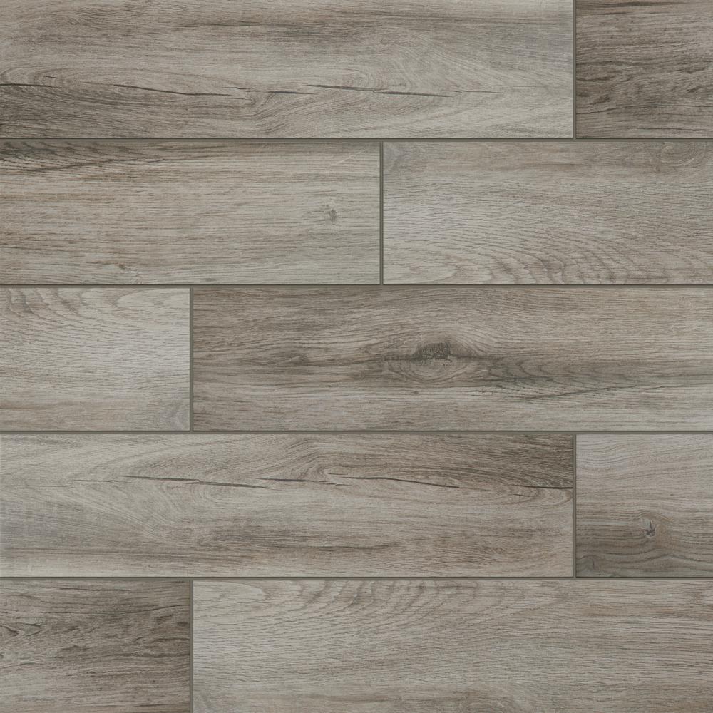 A close up of a tile floor that looks like wood.