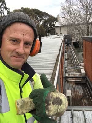 worker fixing roof