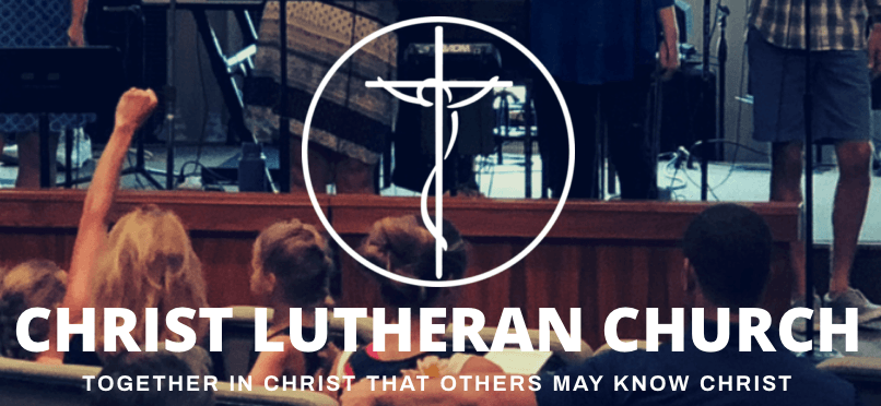 A group of people are sitting in front of a stage at christ lutheran church.